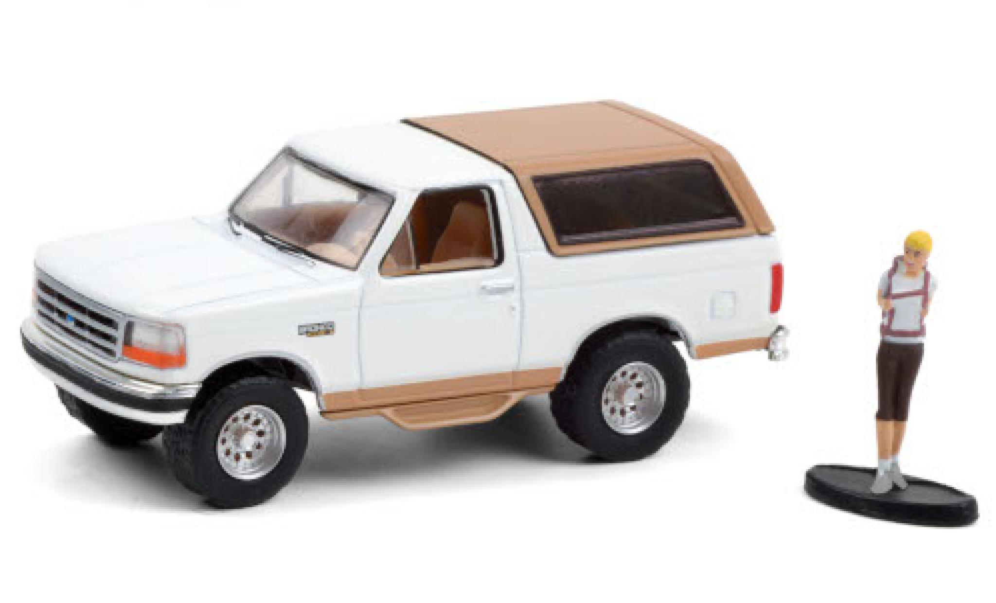 Ford Bronco 1/64 Greenlight Eddie Bauer wit/matt-beige 1996 avec figurine modelauto