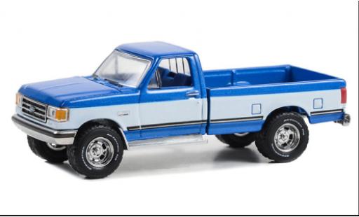 Modelauto Ford F-150 XLT 50 Lariat metallic blauw/wit 1988 1/64 Greenlight